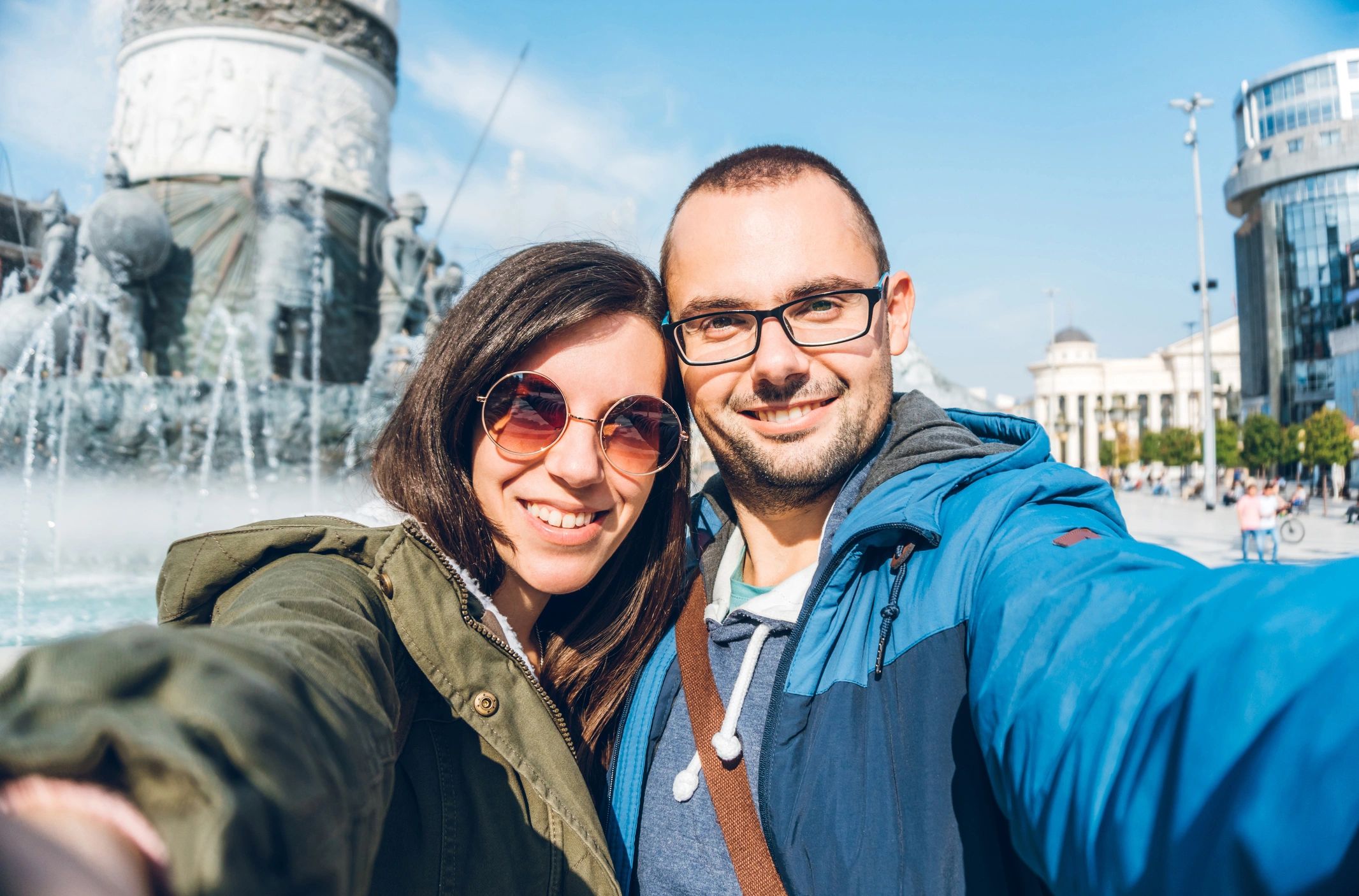 Young tourist couple is making selfies / vlogging