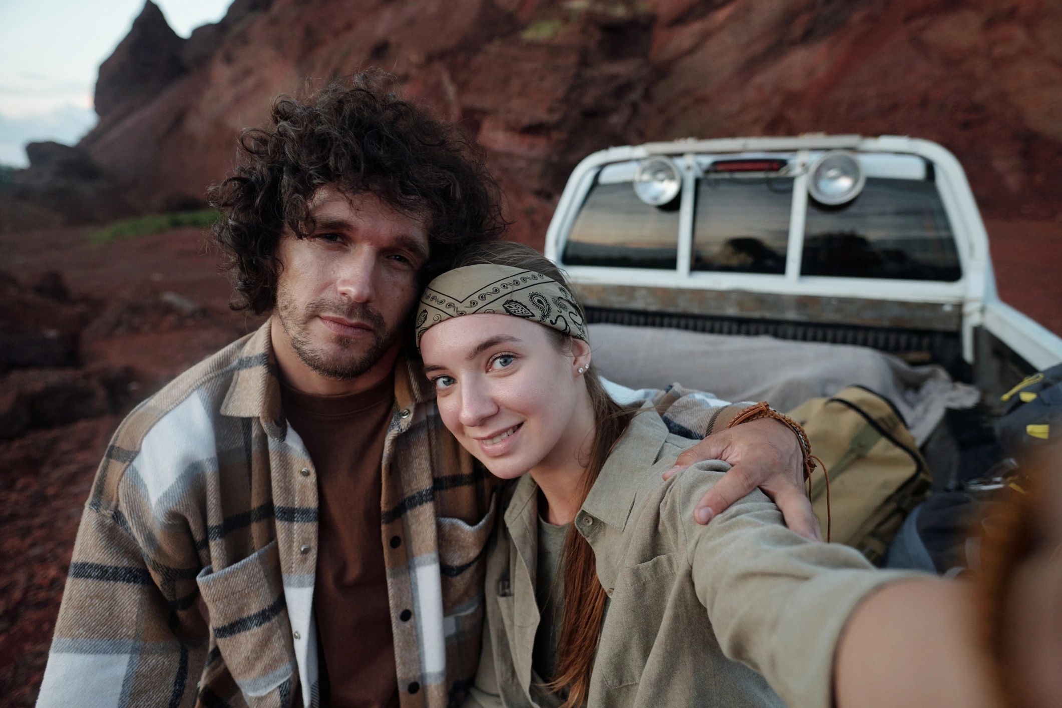 Happy young female backpacker taking picture of herself