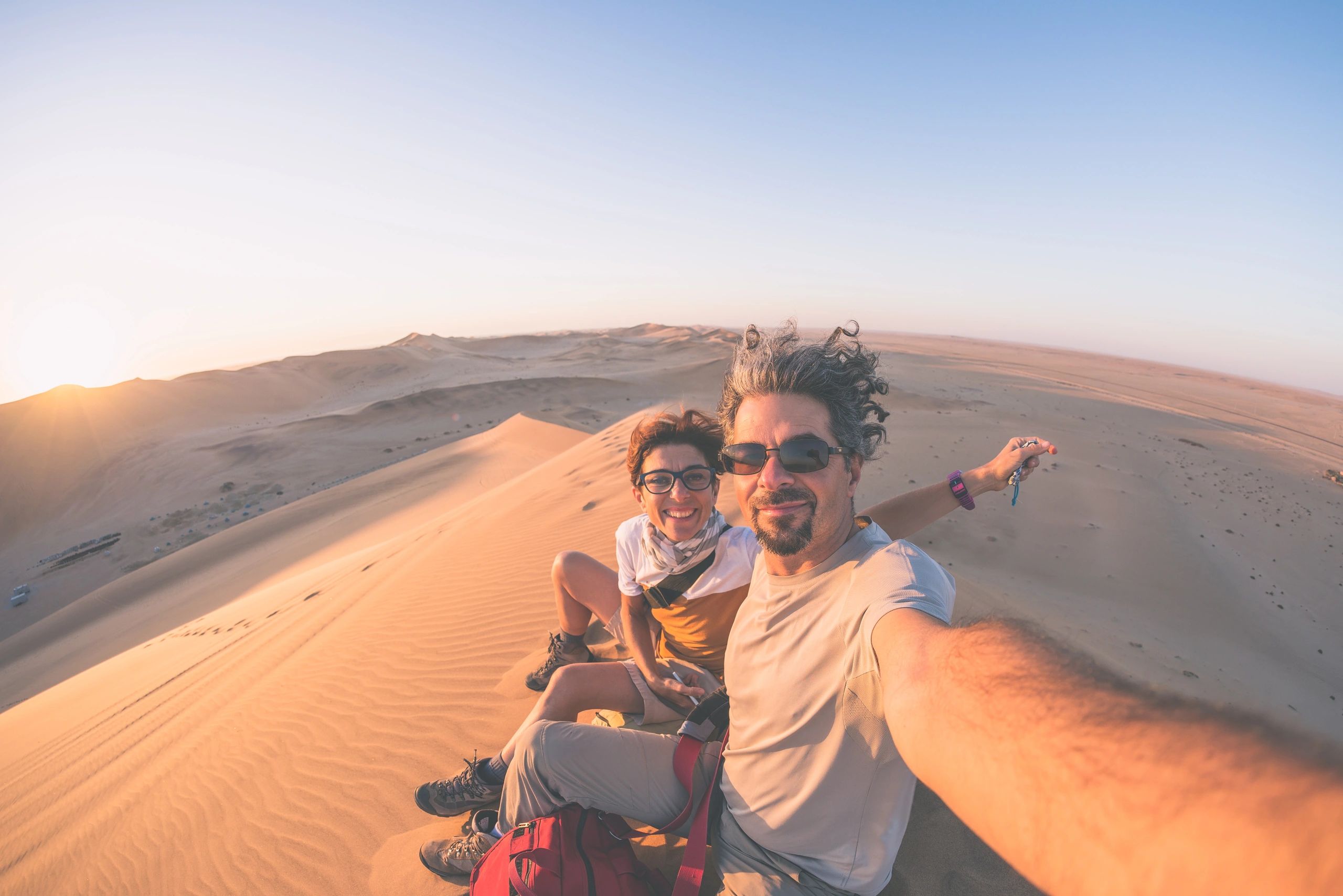 Adult couple taking selfie on sand dunes in